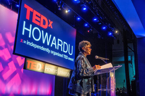 Woman speaking at TedX HowardU Event