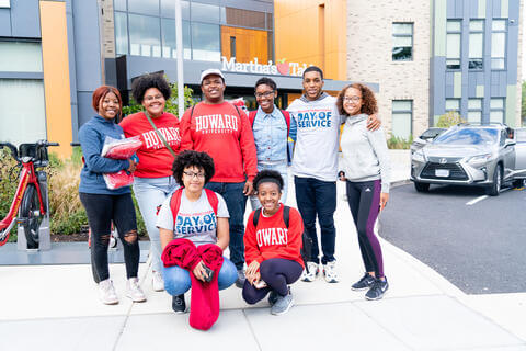 Students posing in a group smiling