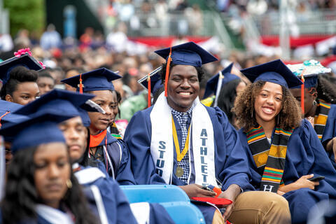 Graduates with cap and gown in the audience